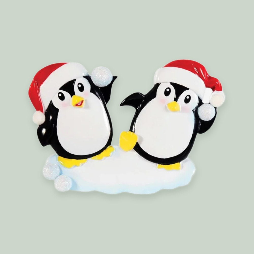 Penguin Snowball Couple ornament on a sage green background