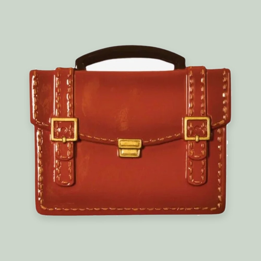Briefcase ornament on a sage green background
