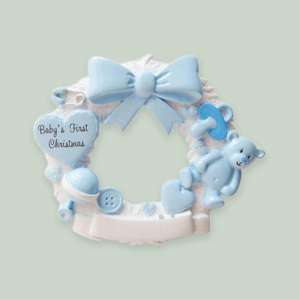 Baby Christmas Wreath (Blue) ornament on a sage green background
