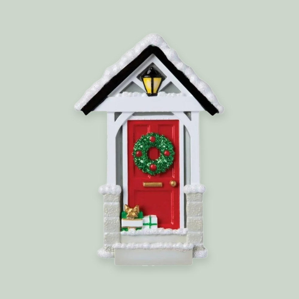 Snowy Roof Christmas Door ornament on a sage green background