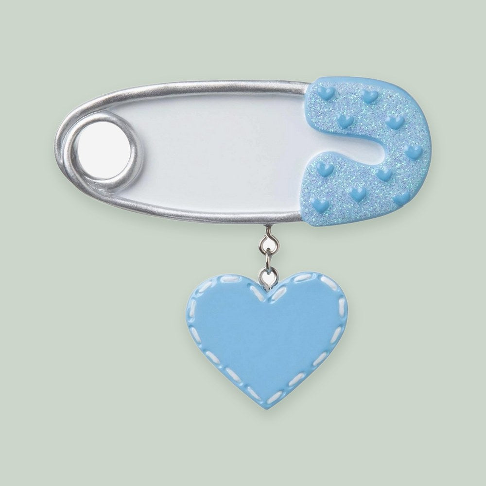 Safety Pin (Blue) ornament on a sage green background