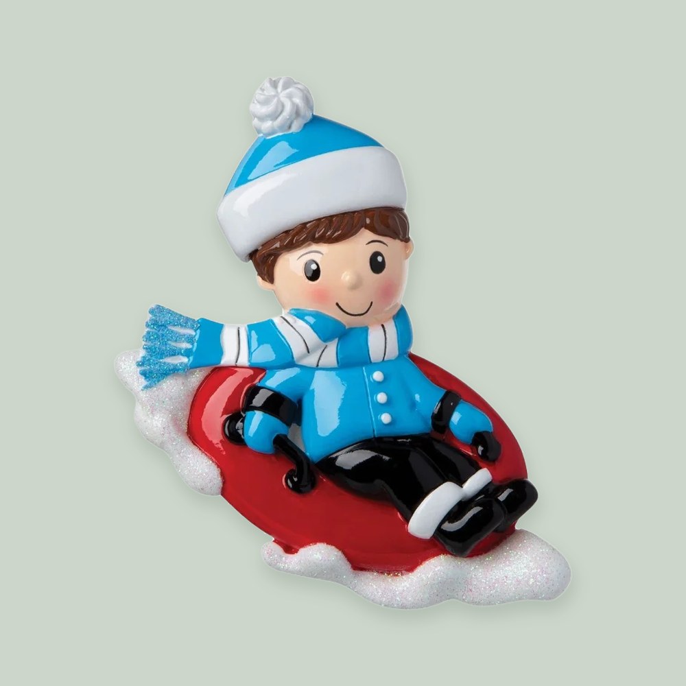 Boy Snow Tubing ornament on a sage green background