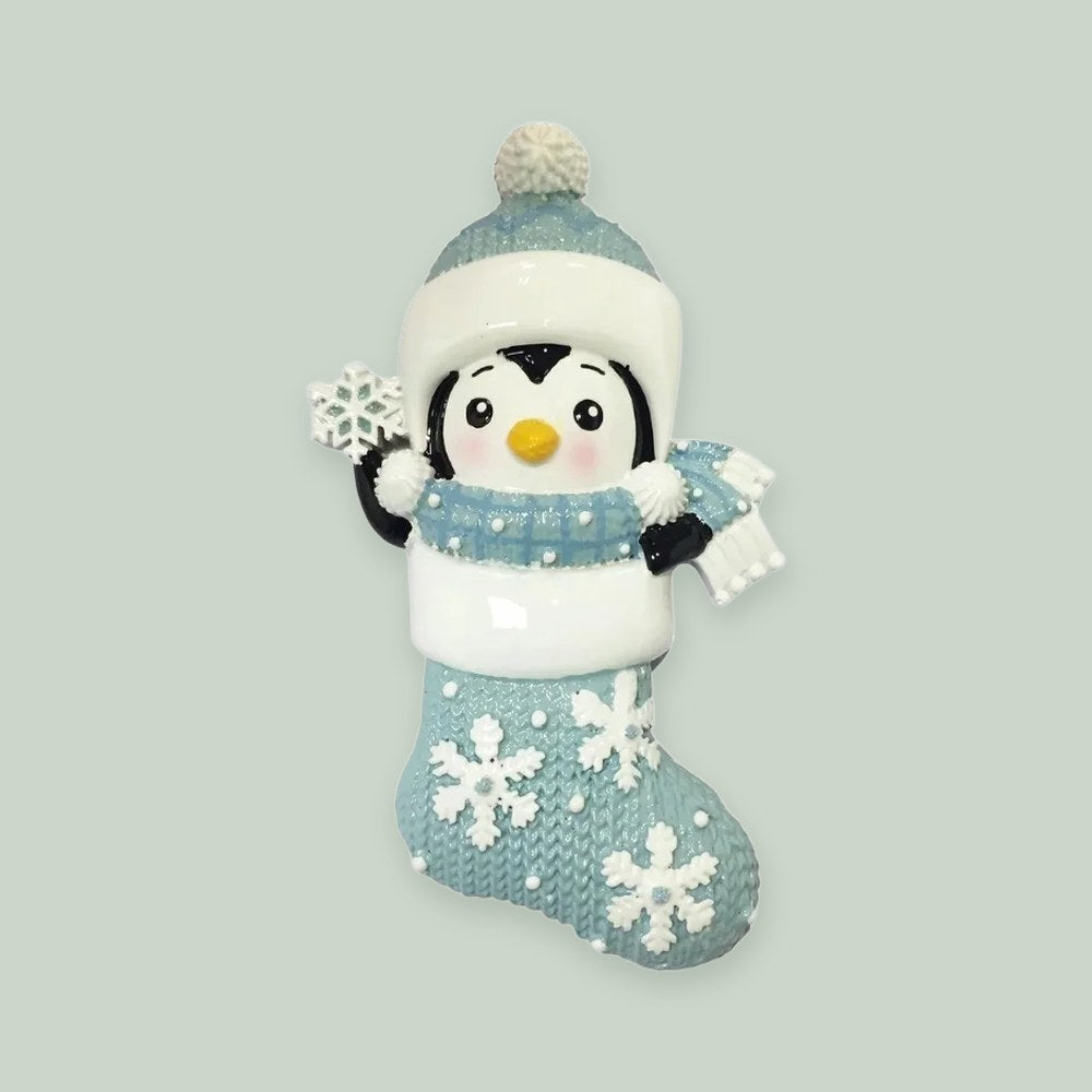 Penguin in Snowflake Stocking – Blue ornament on a sage green background