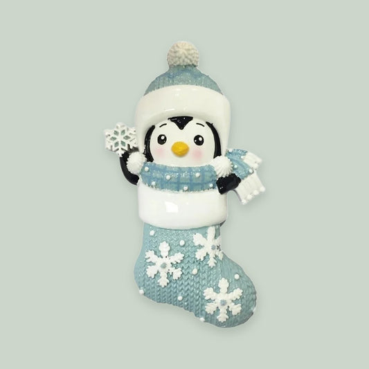 Penguin in Snowflake Stocking – Blue ornament on a sage green background