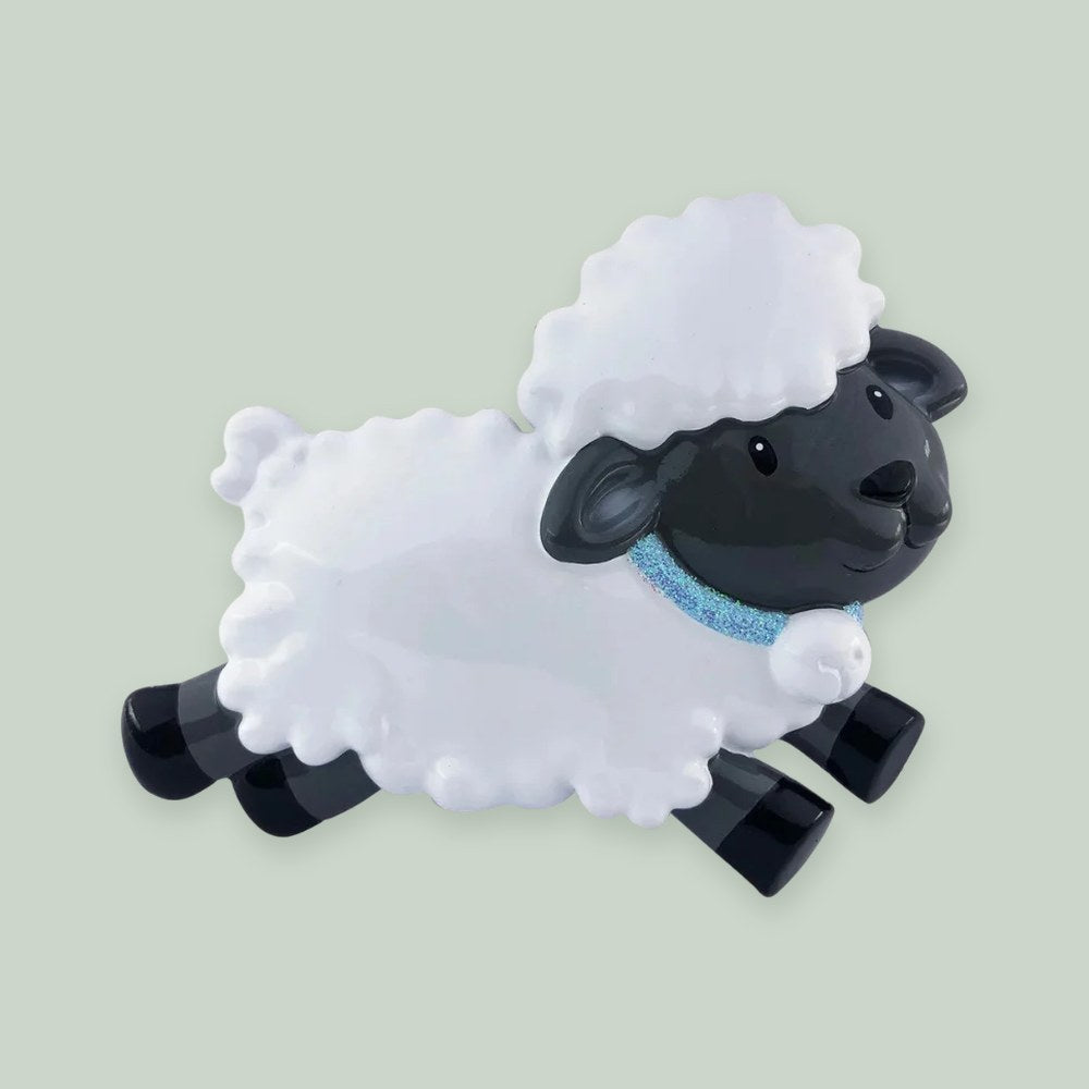 Baby’s First Sheep (Blue) ornament on a sage green background