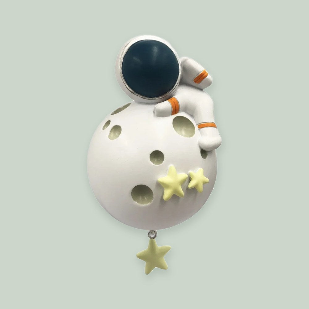 Astronaut ornament on a sage green background
