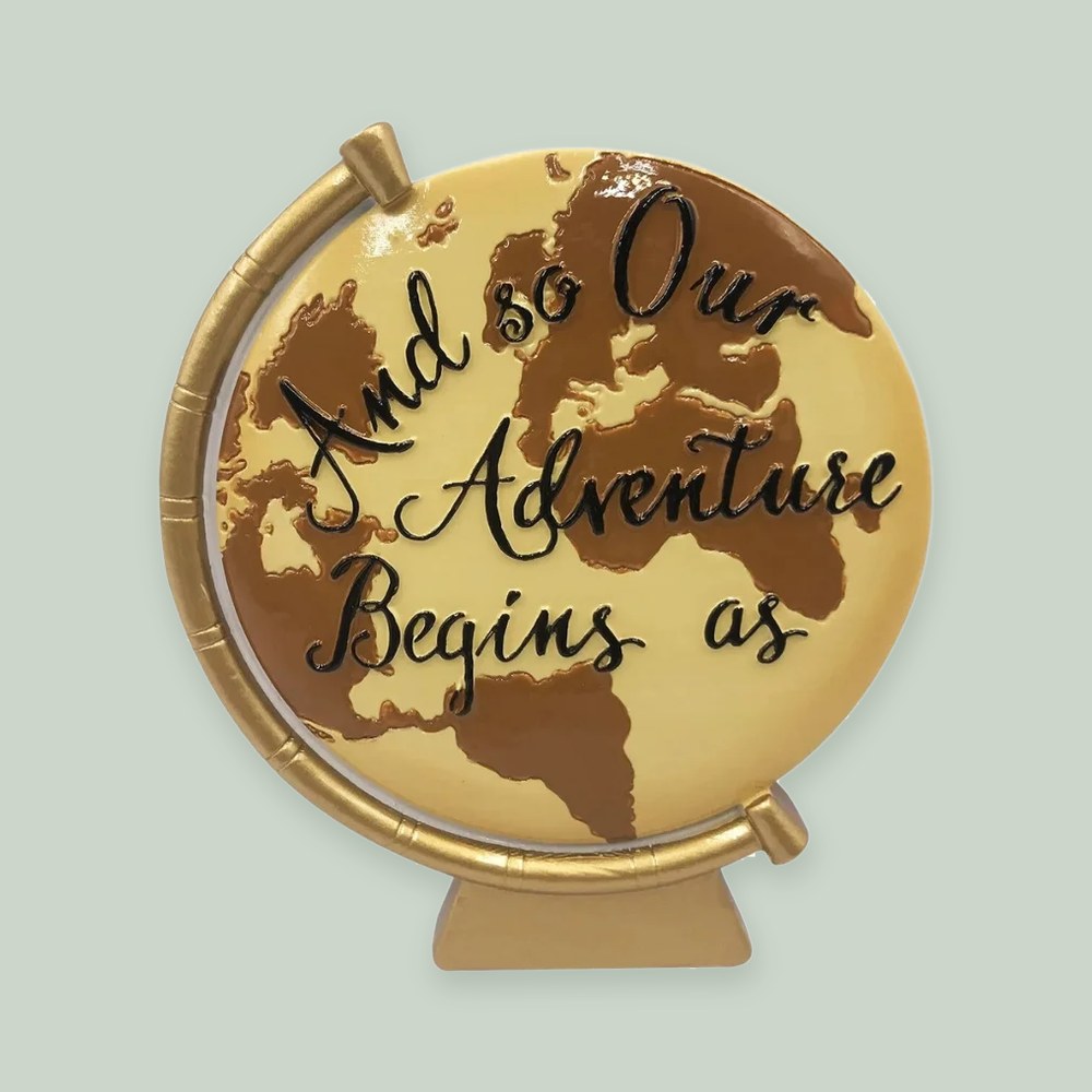 And Our Adventure Begins Globe ornament on a sage green background