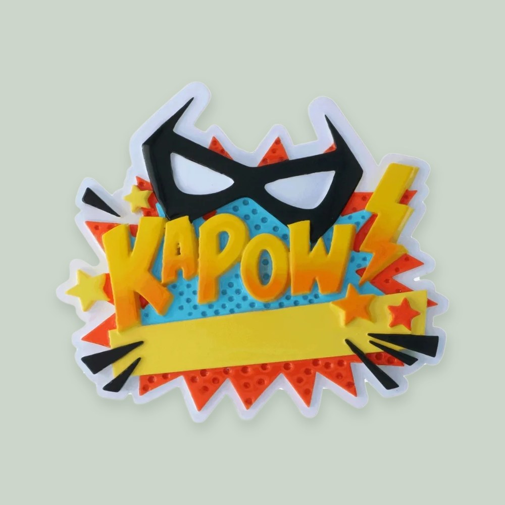 “KAPOW” Super Hero ornament on a sage green background