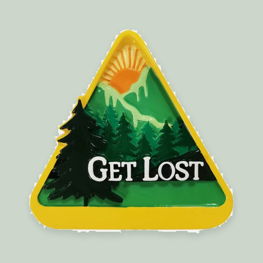 3D “Get Lost” Hiking Badge ornament on a sage green background