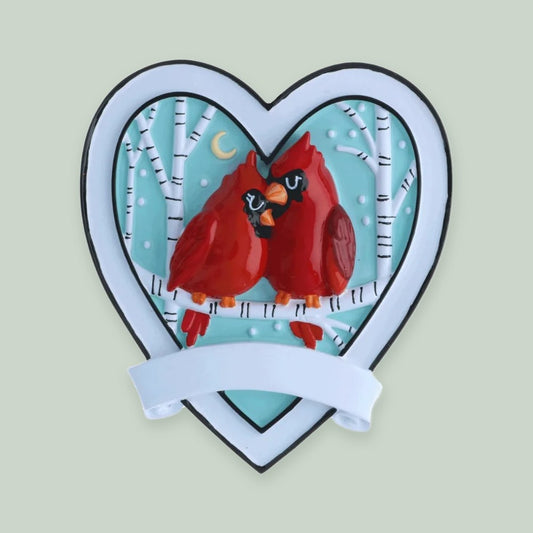 Cardinal Couple Heart ornament on a sage green background
