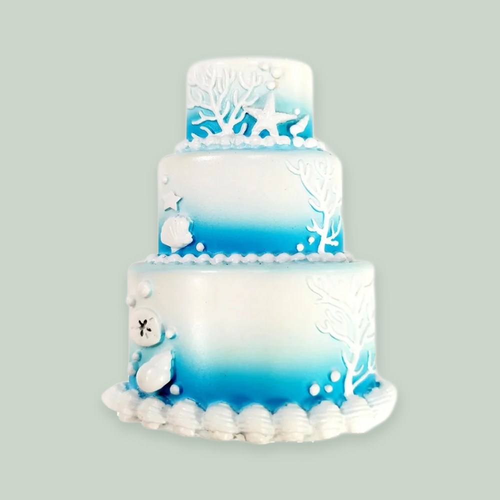 Coastal Wedding Cake ornament on a sage green background