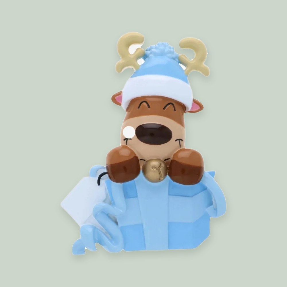 Baby Reindeer in Gift Box (Blue) ornament on a sage green background