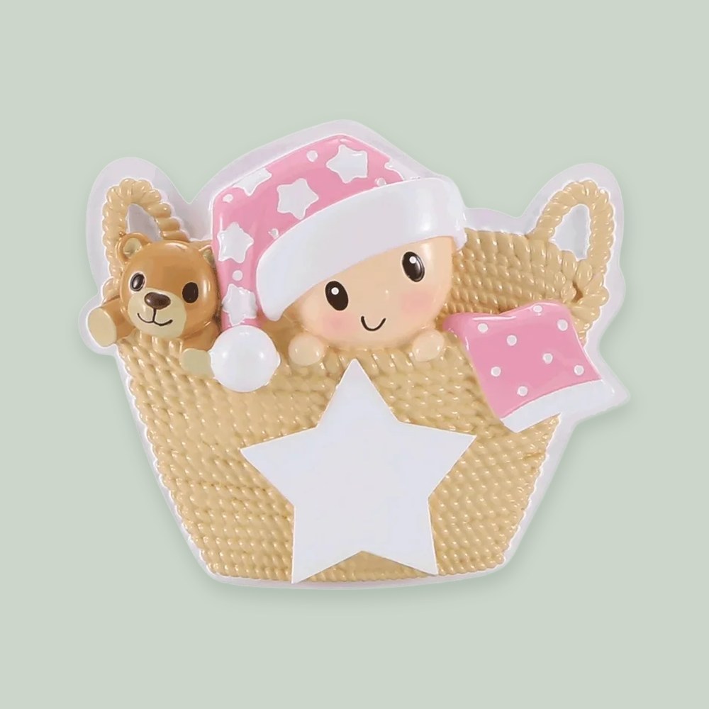 Baby in Basket (Pink) ornament on a sage green background