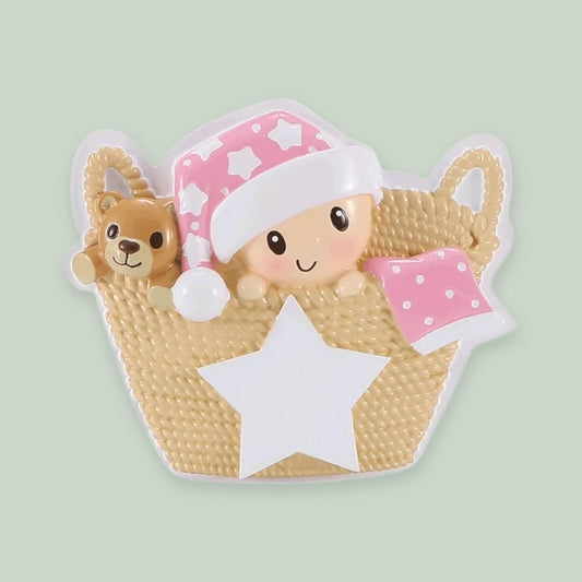 Baby in Basket (Pink) ornament on a sage green background
