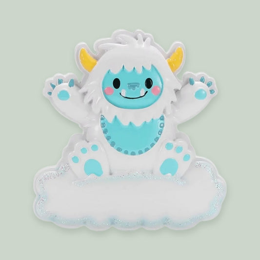 Baby Yeti (Blue) ornament on a sage green background