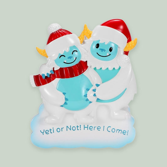We're Expecting Yeti Couple ornament on a sage green background