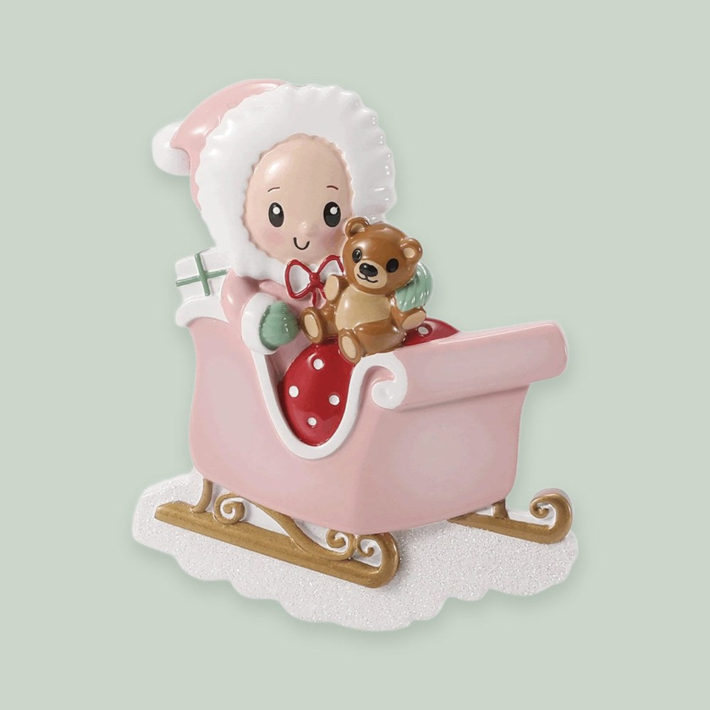 Baby in Sleigh — Pink ornament on a sage green background
