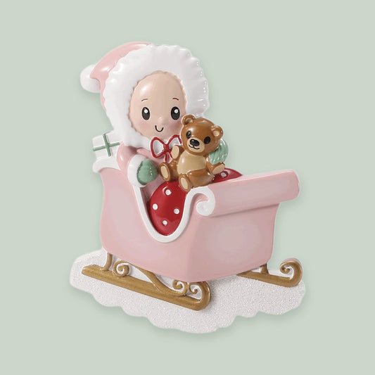 Baby in Sleigh — Pink ornament on a sage green background