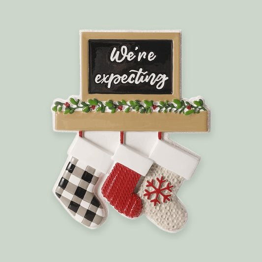 Fireplace Mantel — We're Expecting ornament on a sage green background