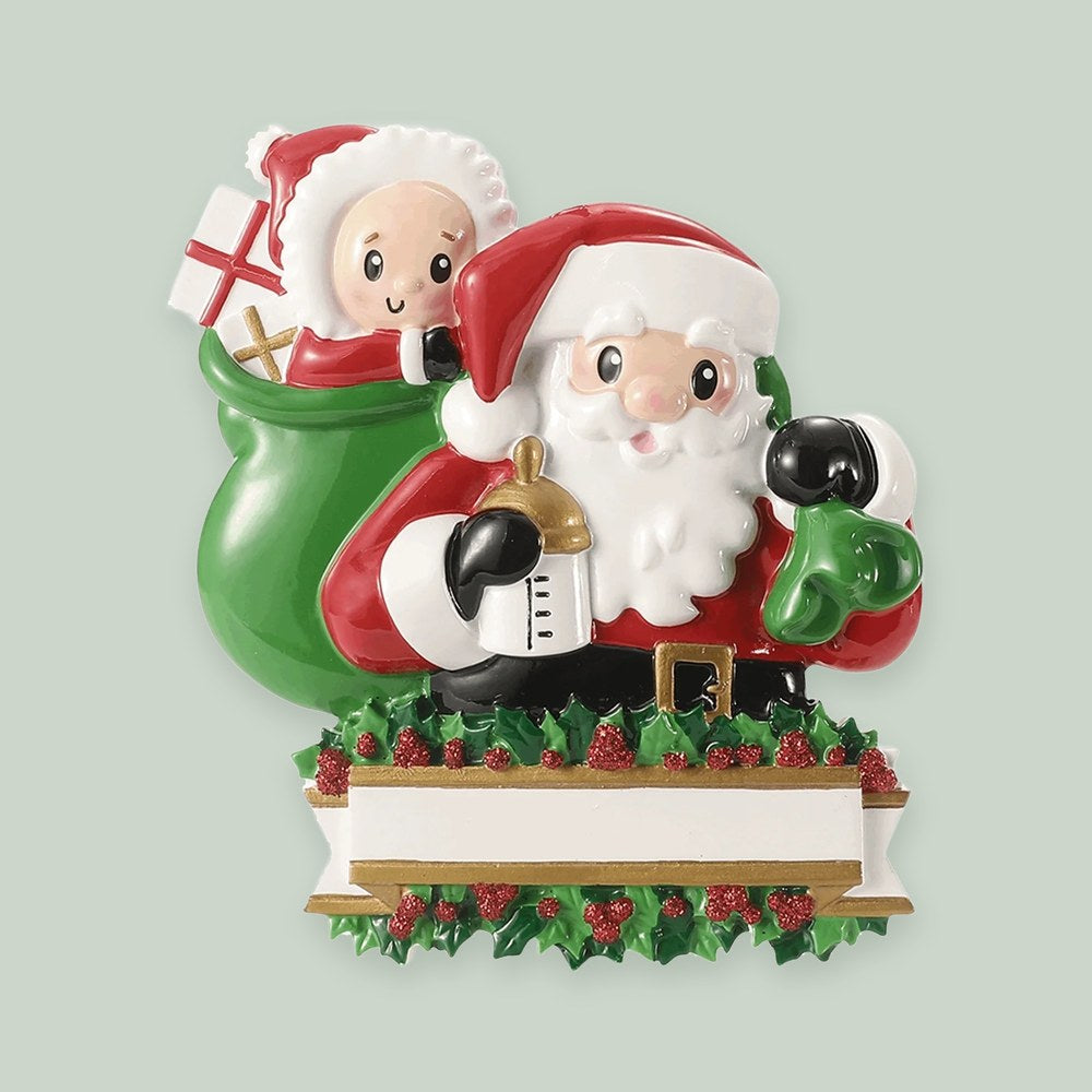Baby in a Santa Sack ornament on a sage green background