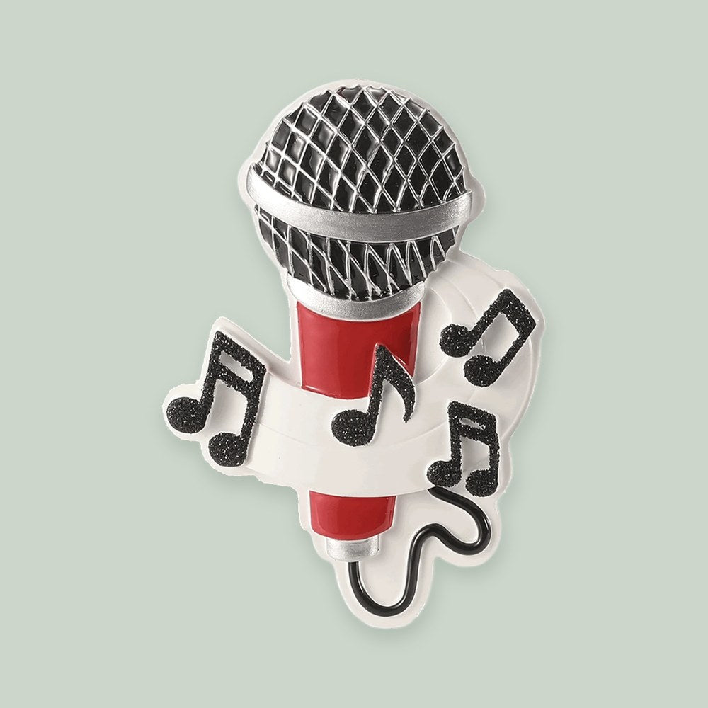 Microphone ornament on a sage green background