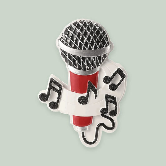 Microphone ornament on a sage green background