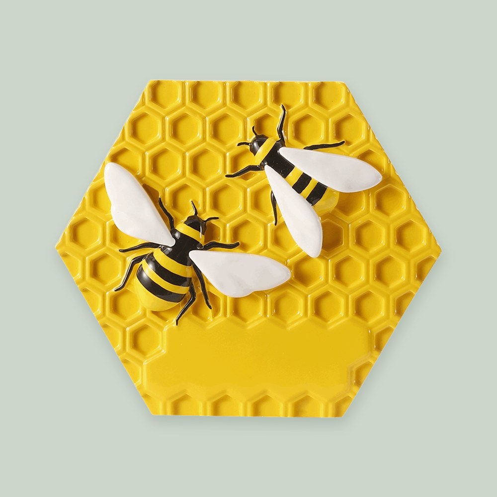 Beekeeper ornament on a sage green background