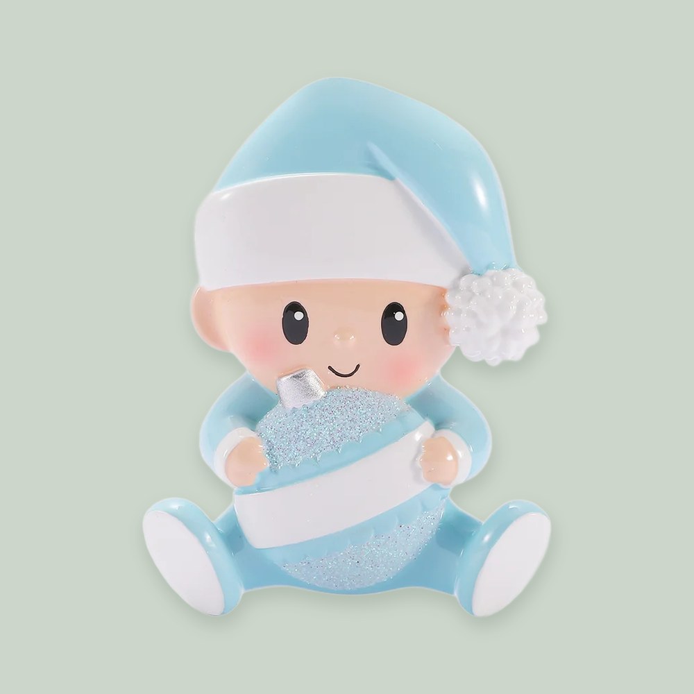 Baby Holding Christmas Bauble — Blue ornament on a sage green background