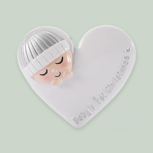 Sleeping Baby in Heart — Silver ornament on a sage green background