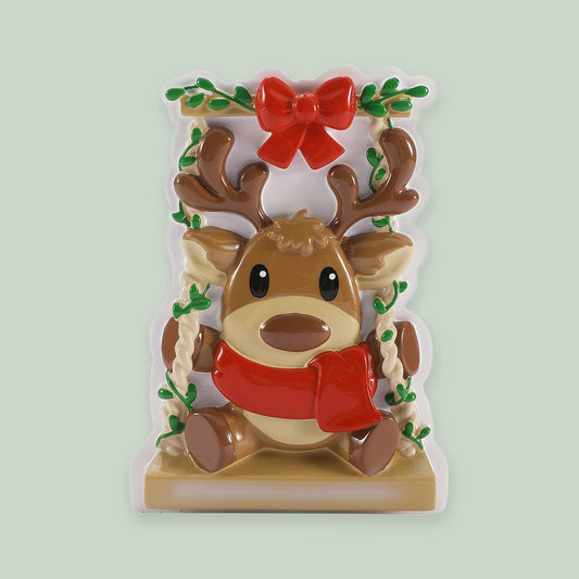 Baby Reindeer on a Garden Swing- Red & Green ornament on a sage green background