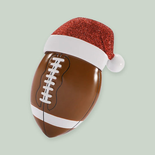 Football with Santa Hat ornament on a sage green background