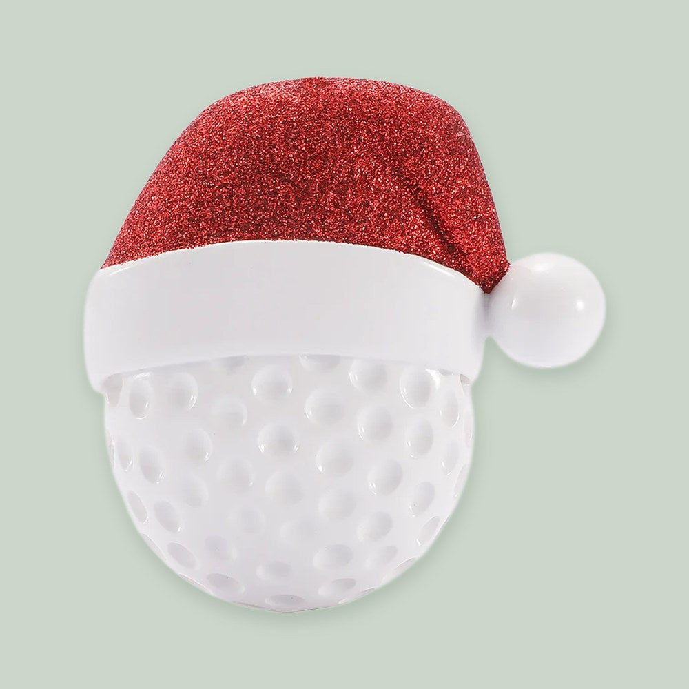 Golf Ball with Santa Hat ornament on a sage green background