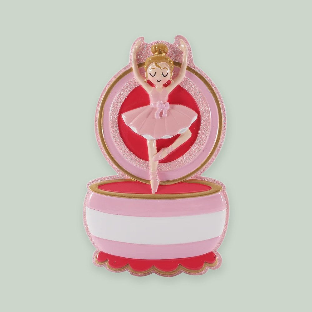 Ballerina Music Box ornament on a sage green background