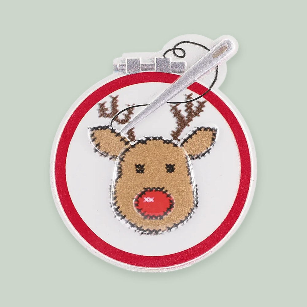Cross Stitching Reindeer ornament on a sage green background