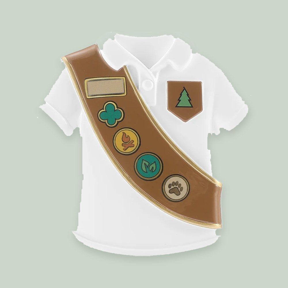 Brownie Scout Uniform ornament on a sage green background