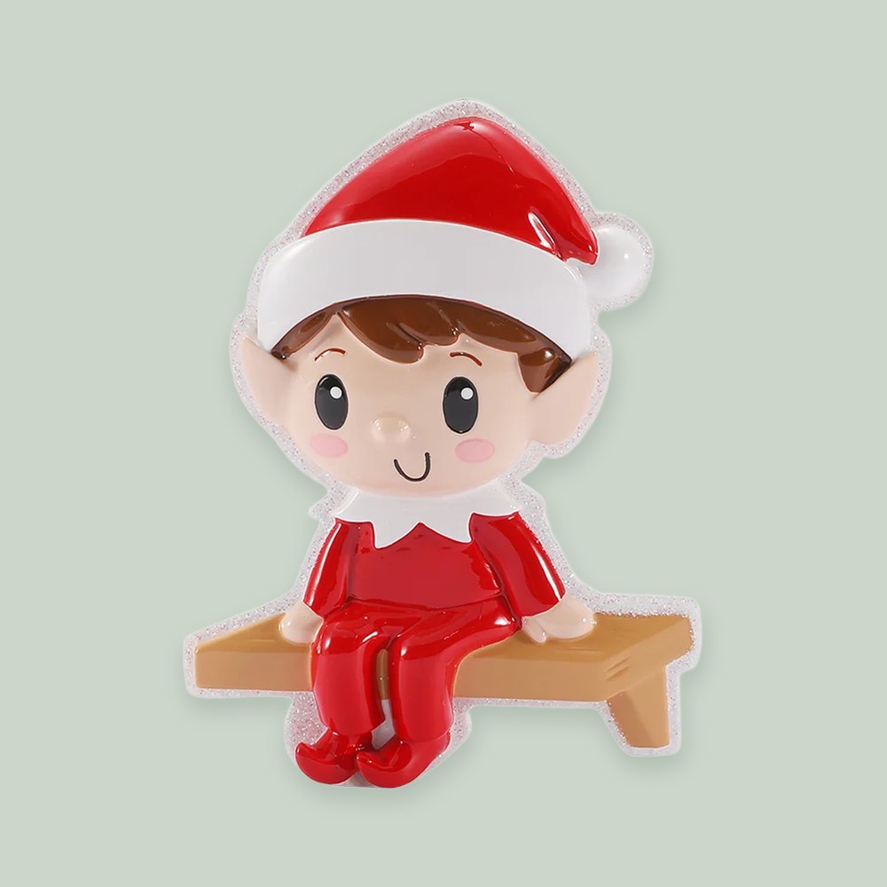 Christmas Elf Sitting On A Shelf ornament on a sage green background