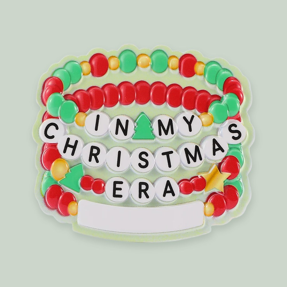 Swifty Christmas Friendship Bracelet ornament on a sage green background
