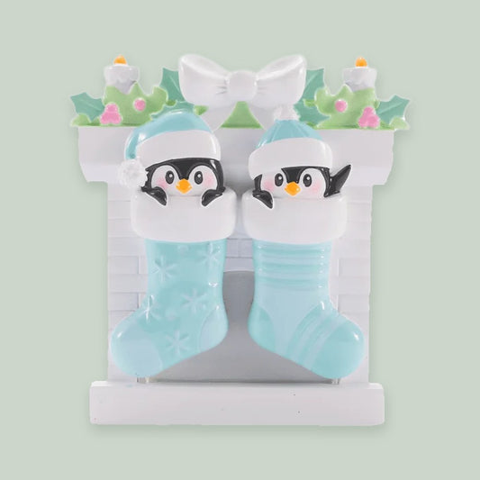 Twin Baby Penguins in Stockings — Boys ornament on a sage green background