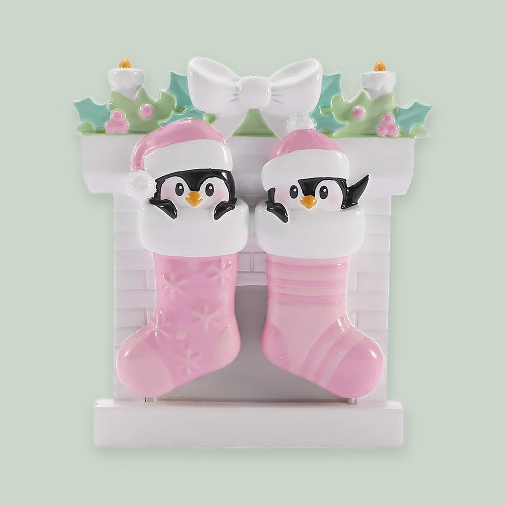 Twin Baby Penguins in Stockings — Girls ornament on a sage green background