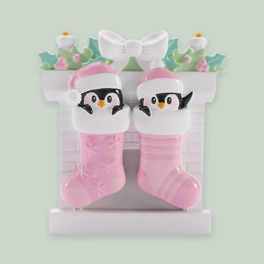 Twin Baby Penguins in Stockings — Girls ornament on a sage green background
