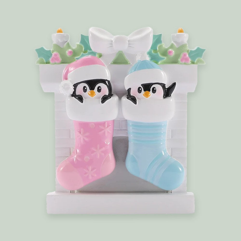 Twin Baby Penguins in Stockings — Boy and Girl ornament on a sage green background