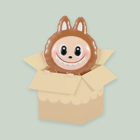 Mystery Box Monster ornament on a sage green background