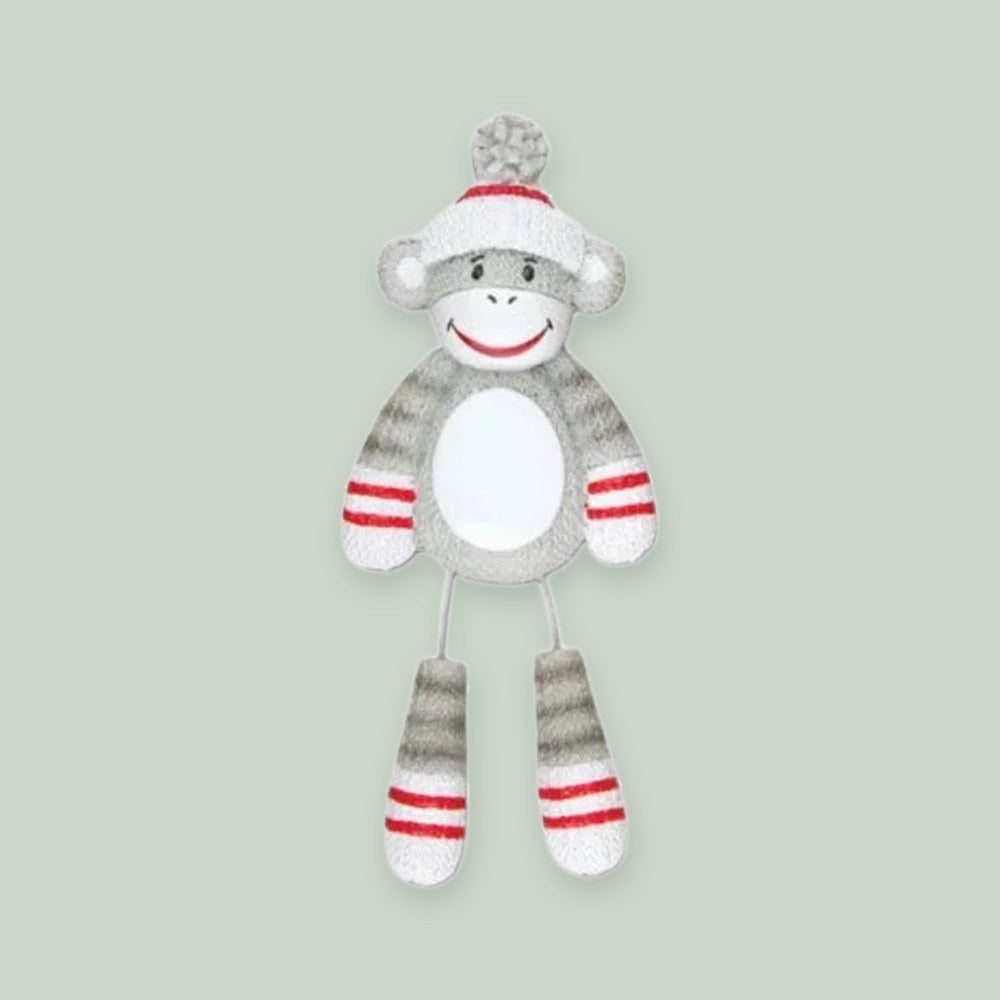 Stuffed Monkey ornament on a sage green background