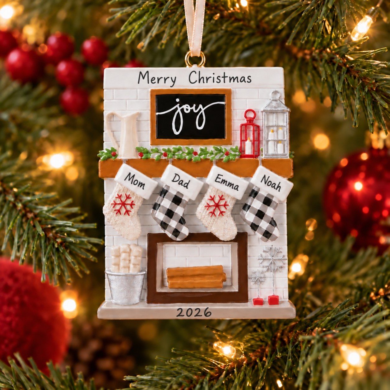 Fireplace ornament with Merry Christmas, Mom, Dad, Emma, Noah, and 2026, hanging on a Christmas tree